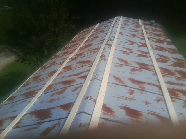 Rusted metal roof panels with new wood purlins before replacement — Storm Damage Roof Repair in Stafford by Roofing Brothers